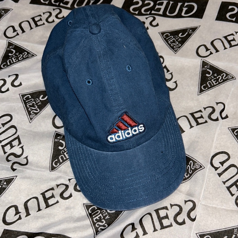 Blue Adidas hat with red stripes